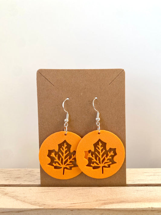 Circular Maple Leaf Earrings in orange.