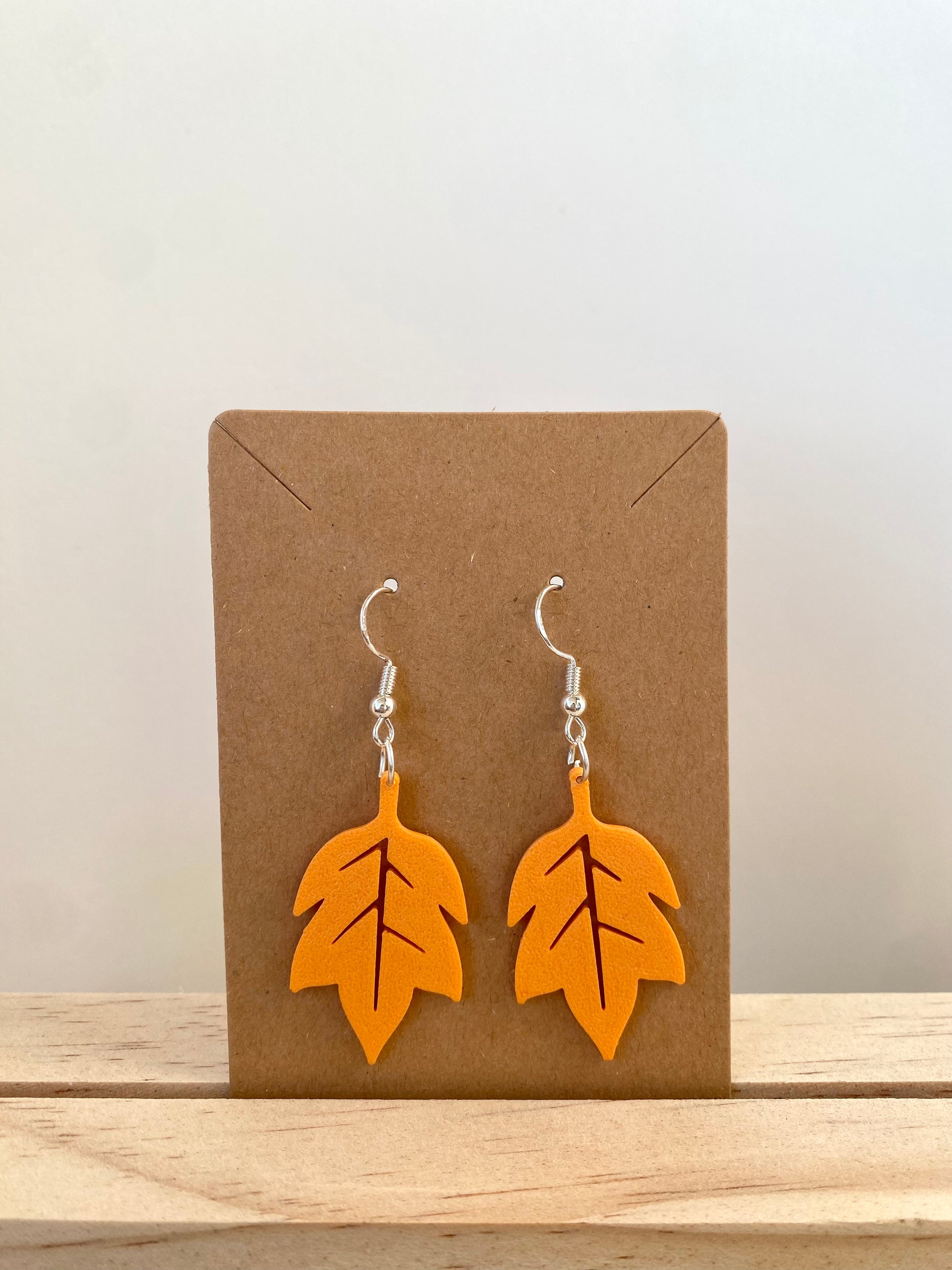 Autumn Red Oak Leaf Earrings in orange.
