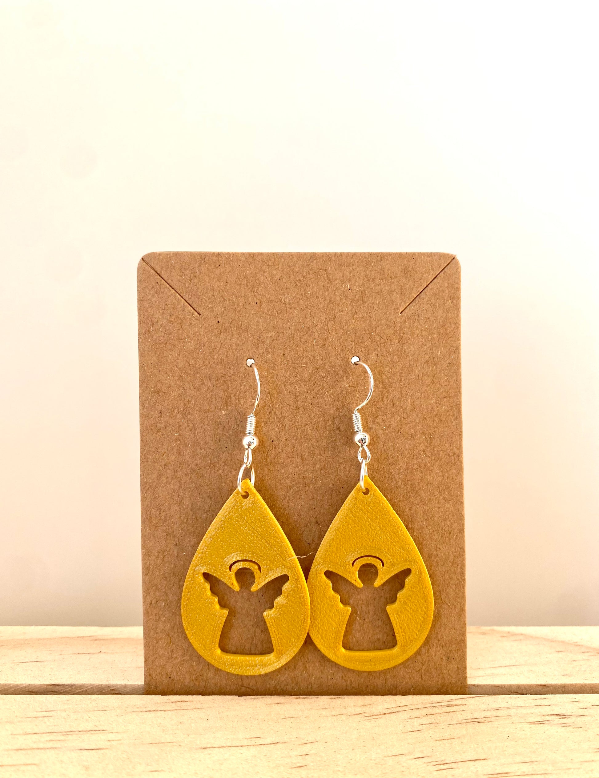 Teardrop Angel Silhouette Earrings in gold.