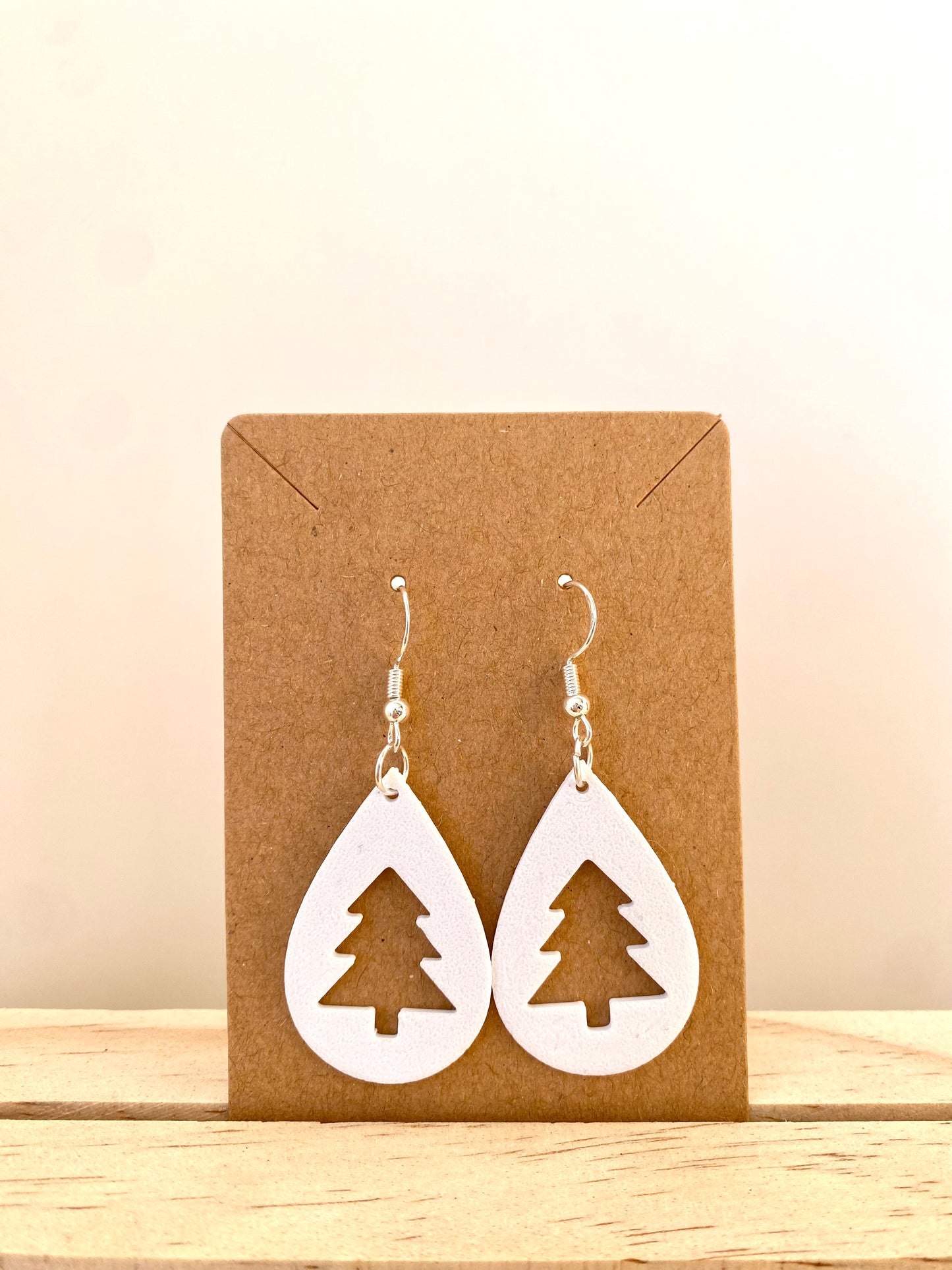 Teardrop Christmas Tree Silhouette Earrings in white.