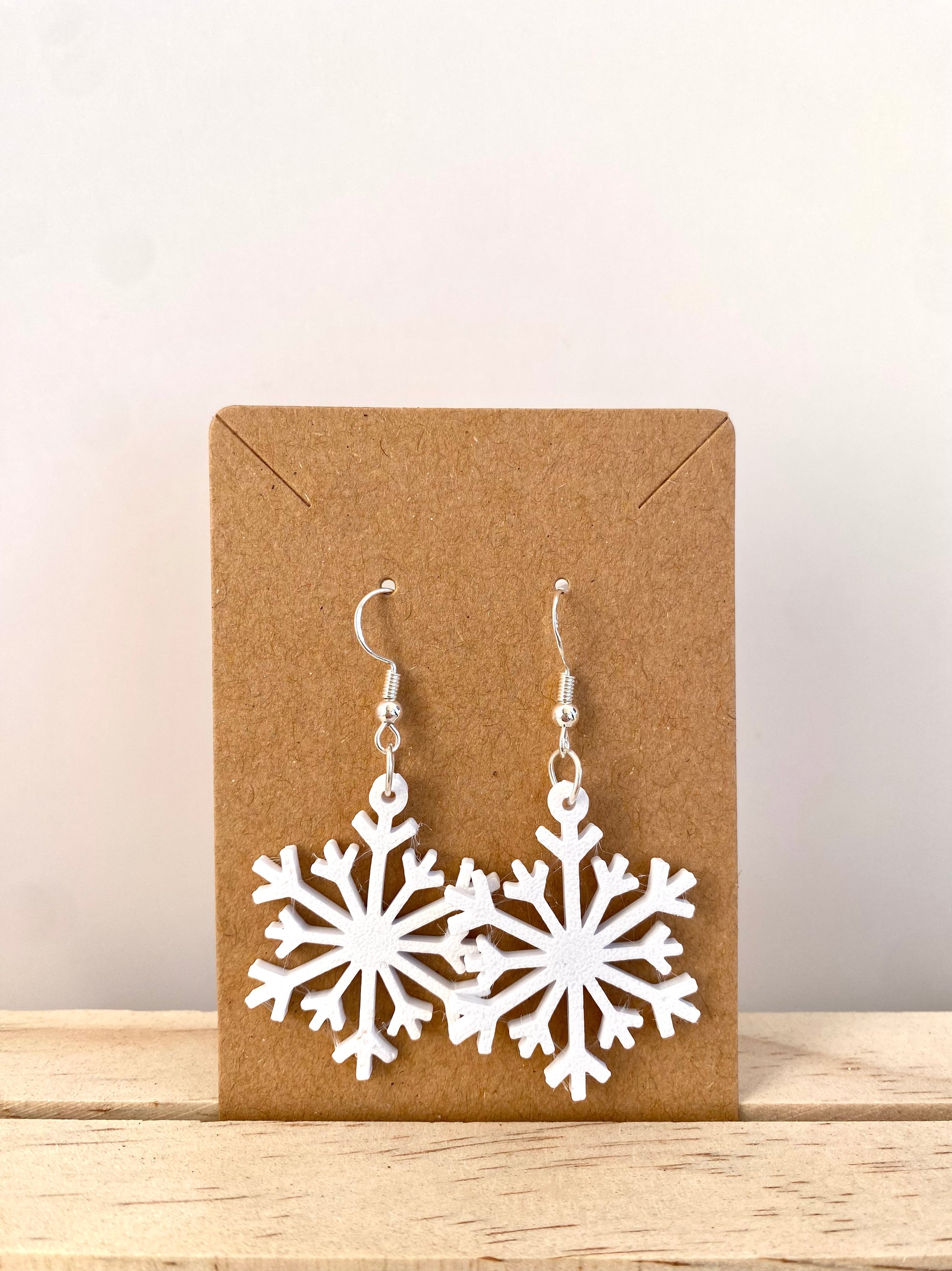 Snowflake Earrings II in white.